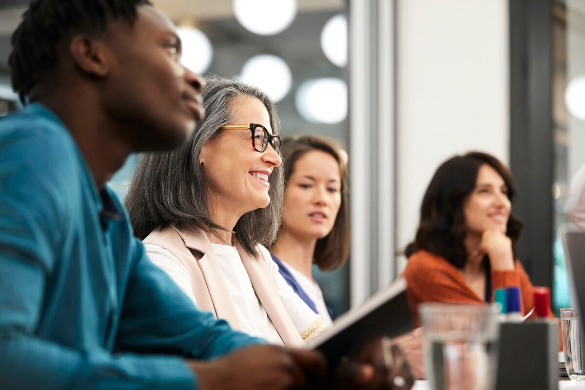 people smiling in a meeting