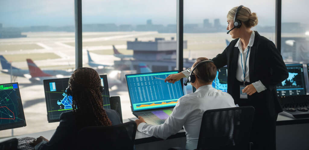 workers at an airport looking at computer screens