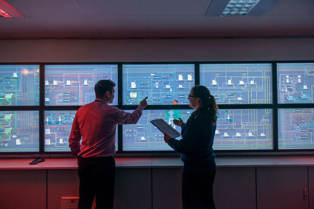 two people looking at a digital wall